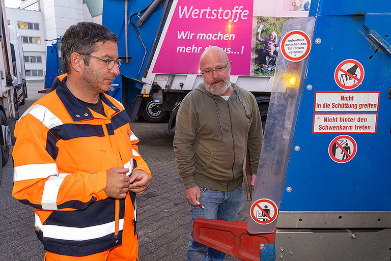 OB Marc Herter bekommt eine Einweisung in die Funktion eines Müllfahrzeug